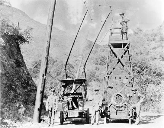 This was the nation's first trackless trolley, built by Charles Spencer Mann in 1910 to promote vacation lots in Laurel Canyon. The trolley ran along Laurel Canyon's dirt road and connected Sunset Boulevard to the base of the current Lookout Mountain Avenue where there was a small inn. The Laurel Tavern served lunch to tourists and prospective customers of Mann's Bungalow Land properties. The ride cost 10¢. More adventurous travelers could continue up Lookout Mountain Avenue for a breathtaking view of Hollywood from the area around the current Appian Way.