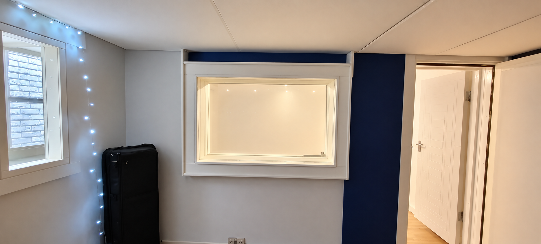 Modern Studio Room with Warm Doorway Lighting.png