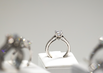 The white-gold solitaire is complete, under glass, and for sale.