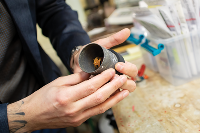 A metal flask encases the wax.