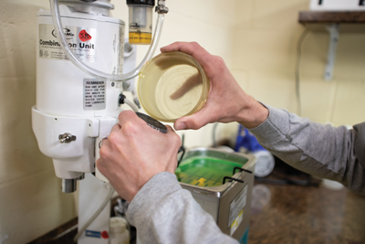A plaster, or “investment” is poured into the flask. Once dry, it is placed in a kiln, burning out the wax and leaving an empty cavity, or mold.