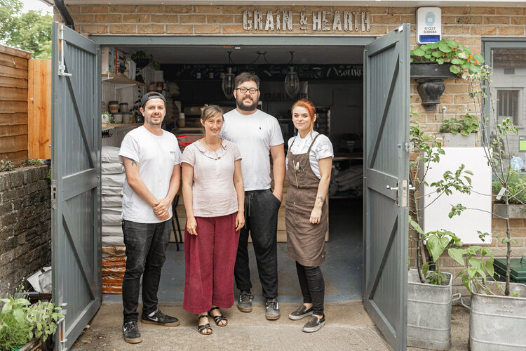 The Grain and Hearth team in front of the newly remodeled bakery. 