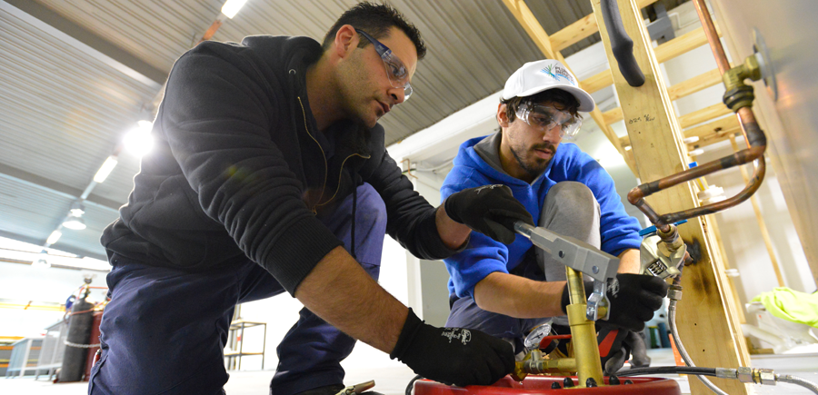 Apprentice and teacher at work.