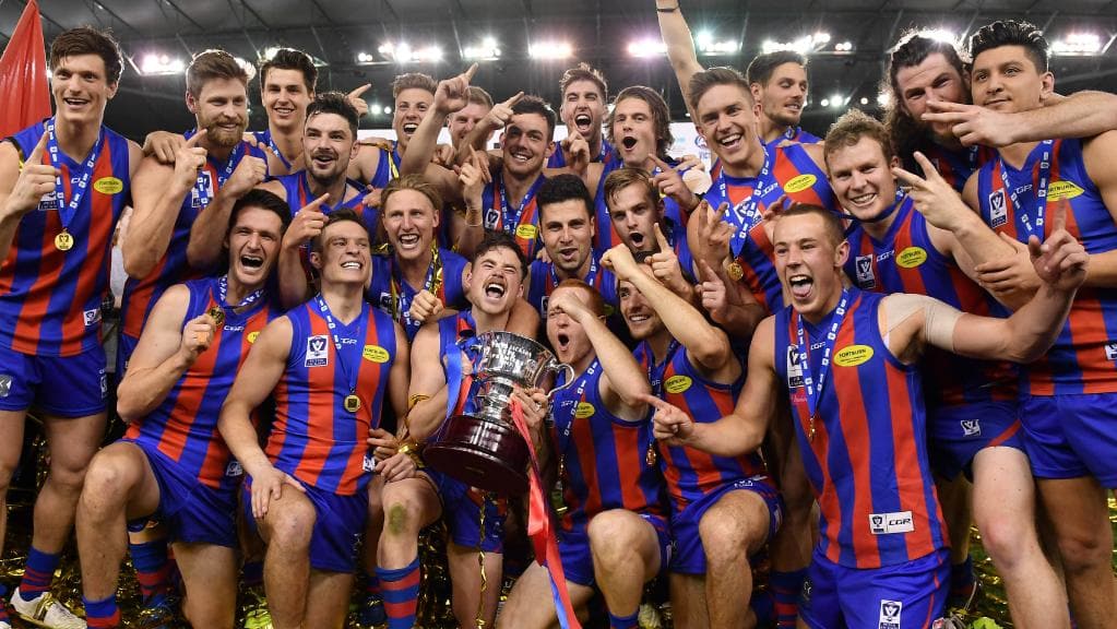 Port Melbourne Football Club players show off the silverware after the club’s VFL premiership triumph in 2017.