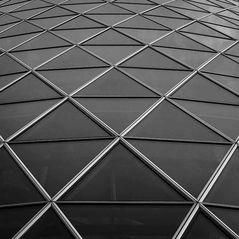 A striking monochrome study of modern geometric architecture in Frankfurt, Germany. The clean repeating lines and glass paneling form a bold abstract pattern, perfect for adding sophisticated contemporary design to modern offices or home interiors.