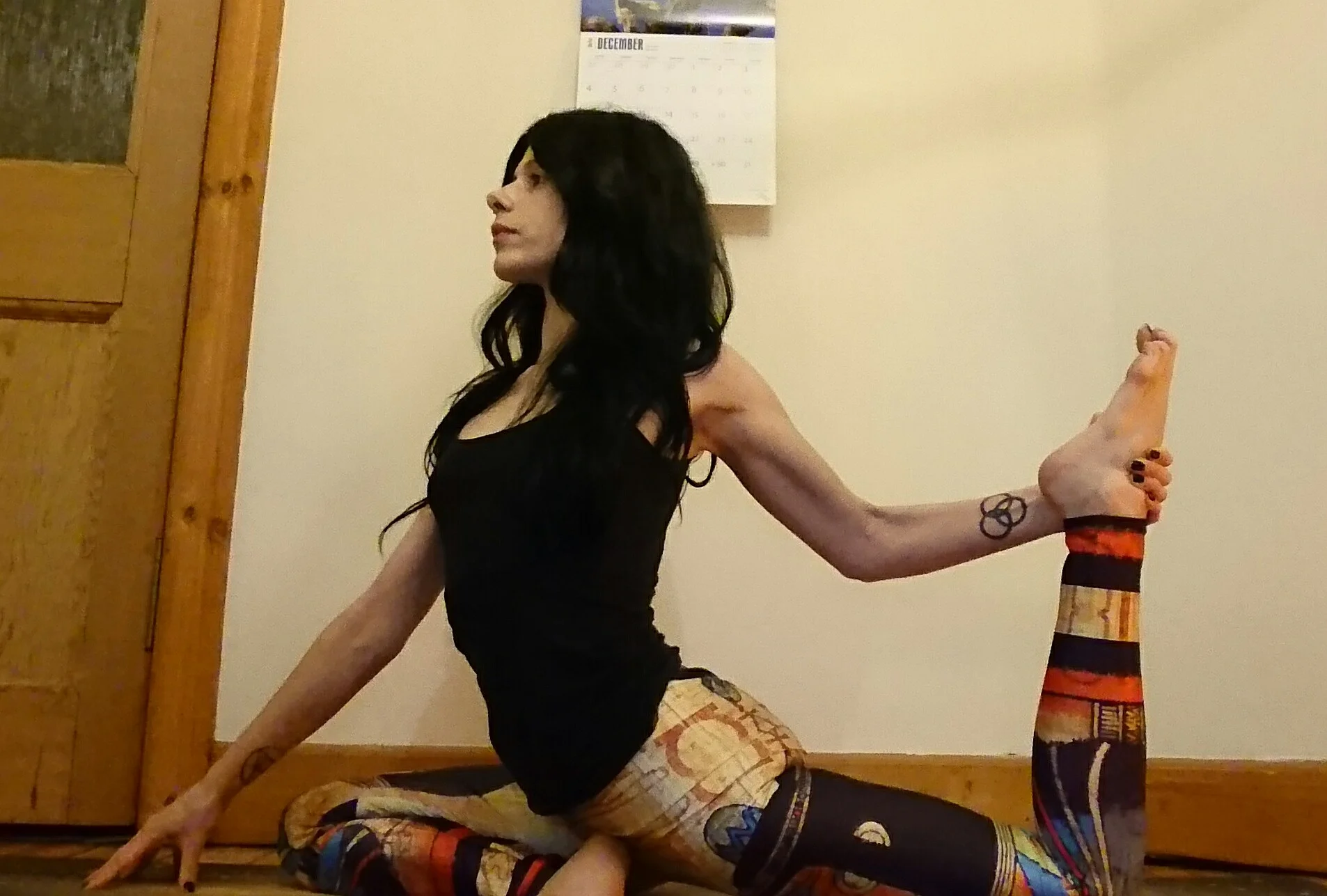 Now it’s time to start getting into Mermaid and One Legged King Pigeon Pose! After sitting comfortably in Pigeon Pose for a few breaths and allowing your hips to relax into the pose, bend your back knee and take a hold of your foot using the hand at the same side as your back leg – you can keep your balance by bringing your other hand down on to the mat in front of you. Gently start to pull your foot towards your body whilst keeping your gaze fixed forwards. You should feel some stretching down your quad muscles at the front of your thigh. Only stretch to a level that is comfortable for you – there shouldn’t be any pain involved in yoga! Listen to your body during your stretches, and if anything doesn’t feel right, release the stretch a little until you feel a bit more comfortable.