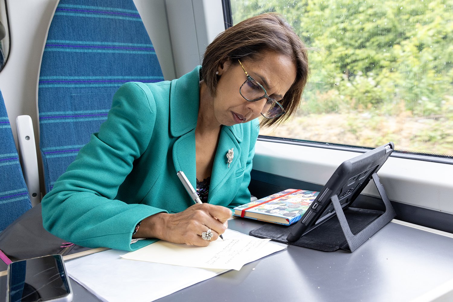 June 2026 Munira Wilson working on the train from Twickenham to London. Nicola Tree is a photo journalist that specialises in photography female politicians and following their careers. Her work is syndicated by Getty Images.
