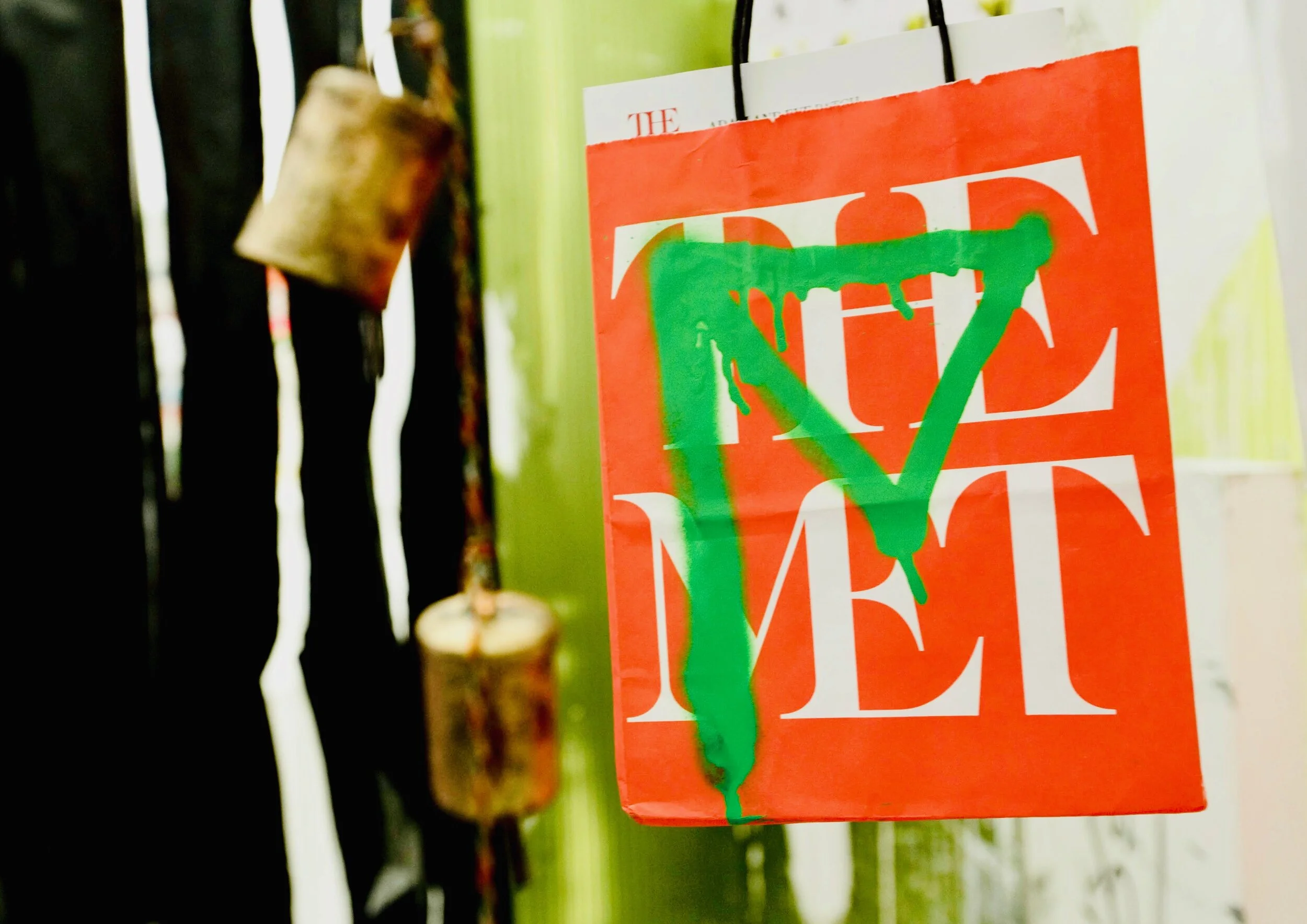 (above) Guzman’s signature phantom figure in green adorning a shopping bag from the Metropolitan Museum of Art