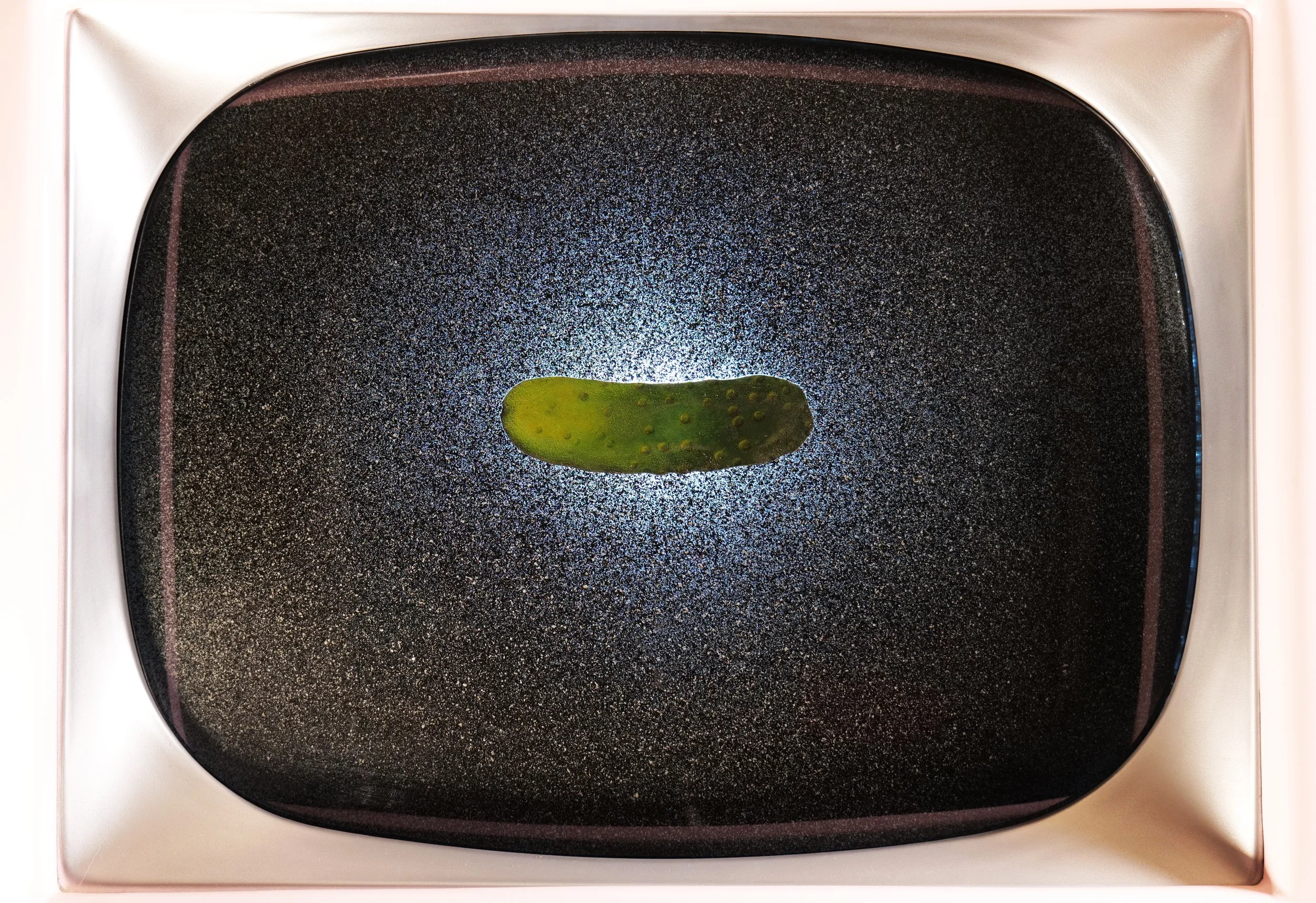 In strobe-action, pickle in a pink box.