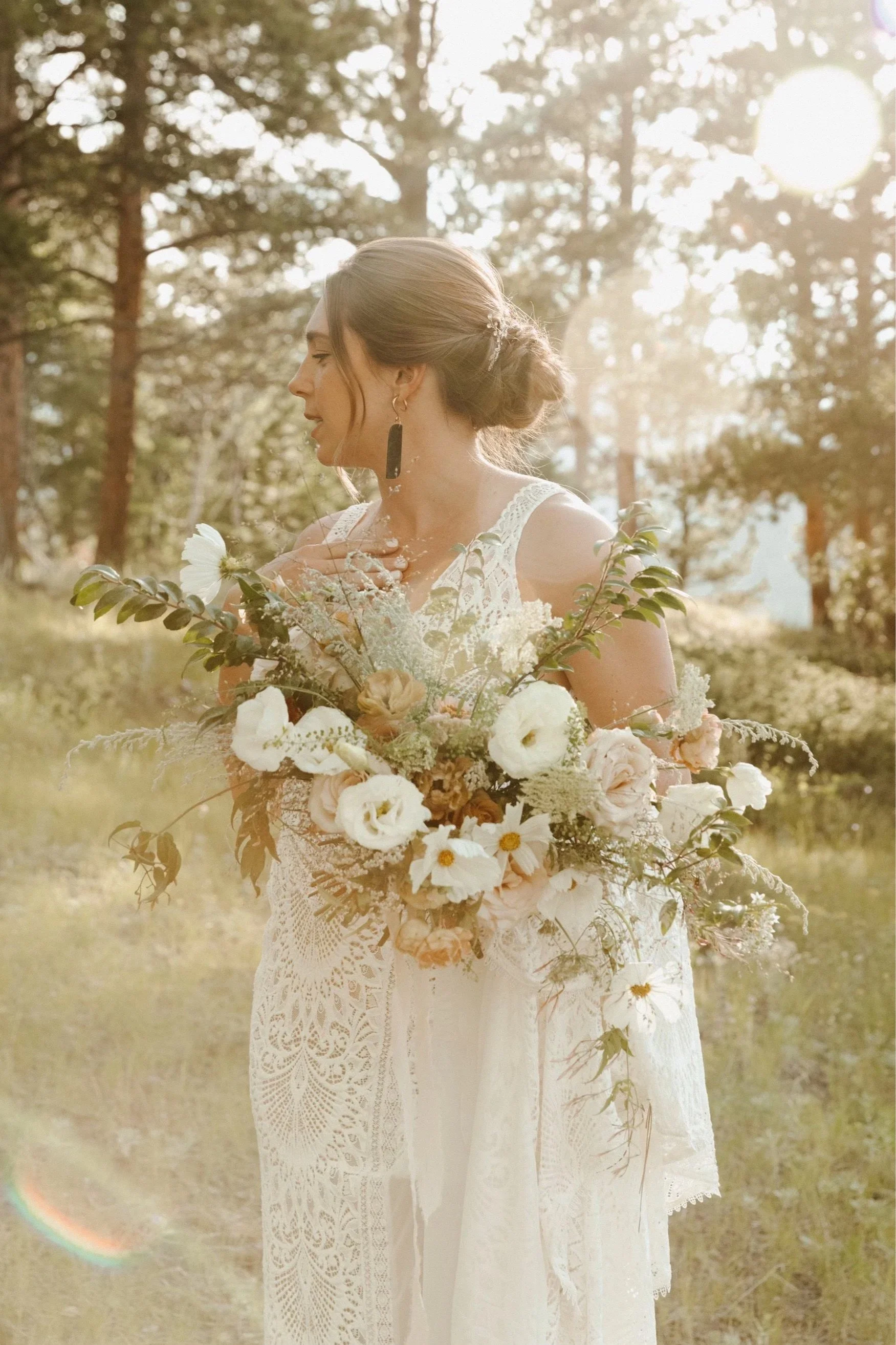 bride holding whimsical, romantic, and lush bouquet of flowers