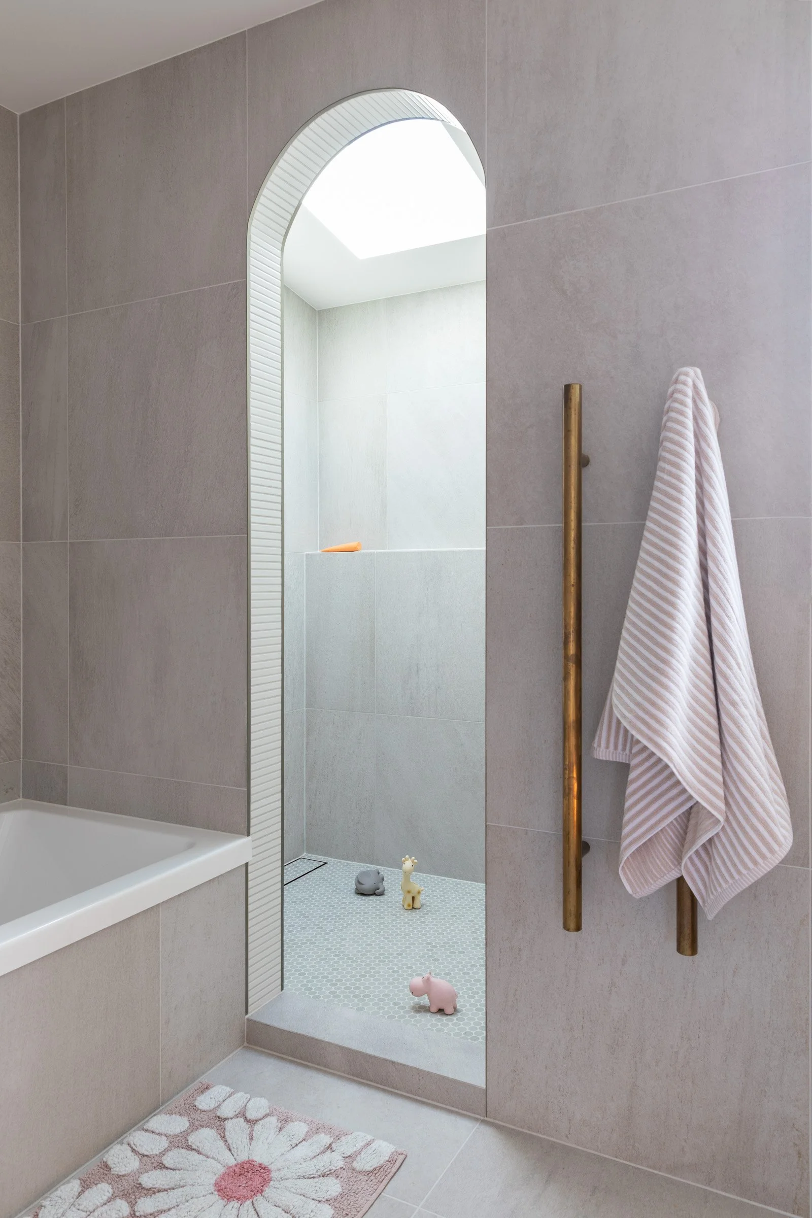 Bathroom with feminine vibes and curved shower entry