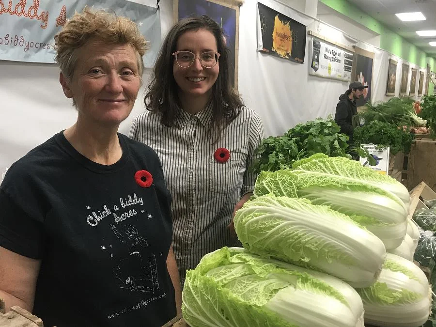Sherry Patterson and Laura Stephens love the new indoor location for the Saturday Market. The Chick-A-Biddy Acres team was busy selling fresh, local produce at the Saturday indoor market. (Photo: Barb Shaw / kawarthaNOW.com)