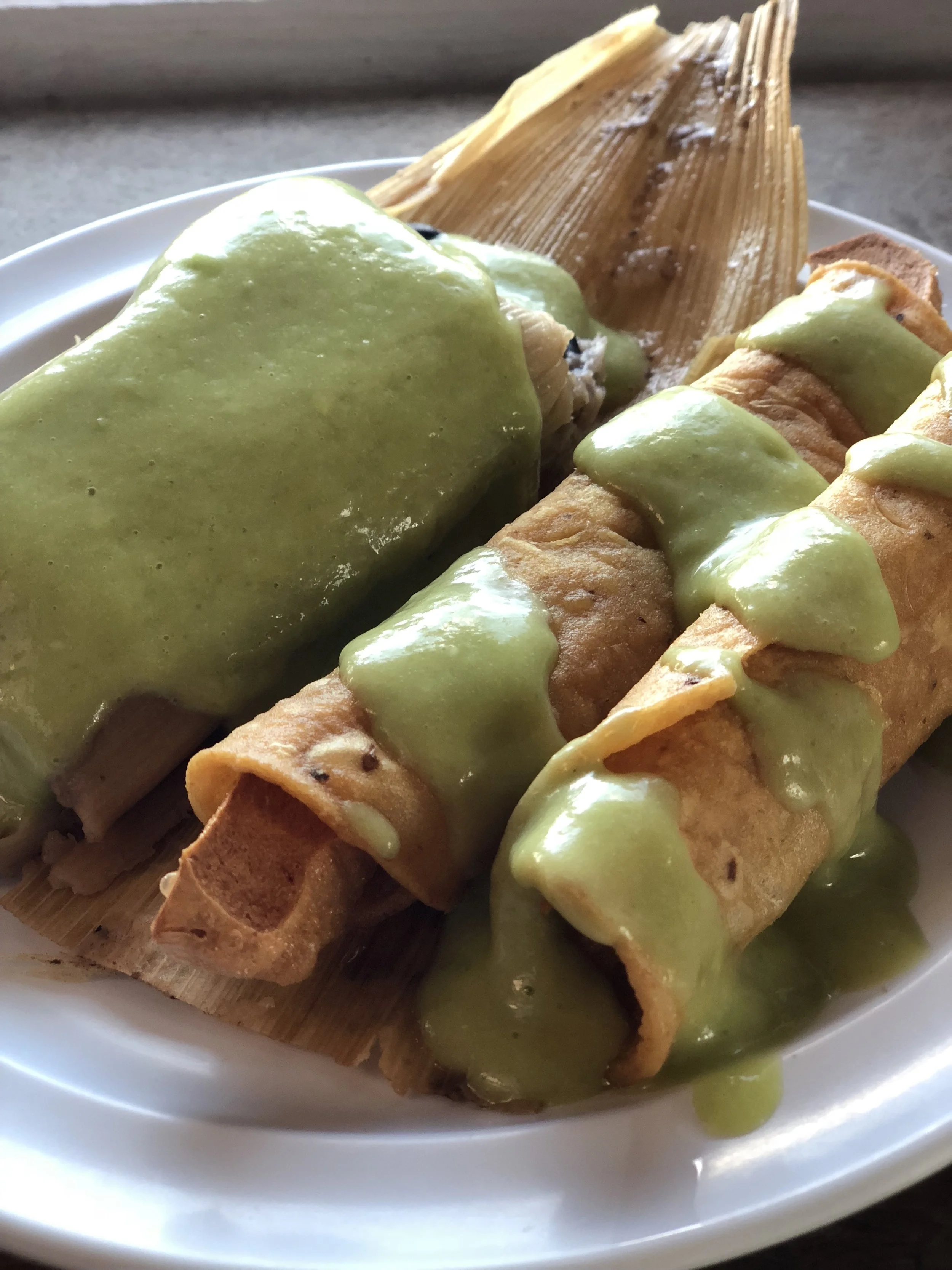 Tamale and two taquitos a la carte, served with mild avocado salsa.