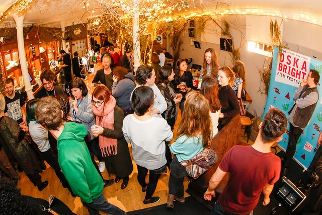 A busy bar full of people at the Oska Bright Film Festival.