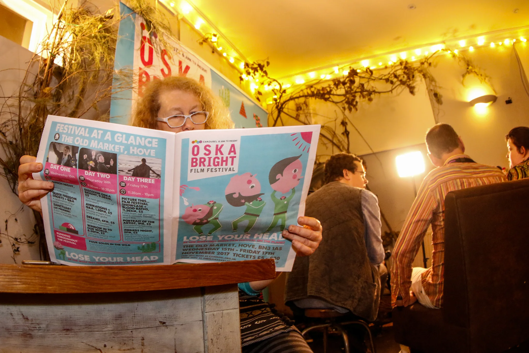 A woman reads the Oska Bright Film Festival programme in the bar at The Old Market.
