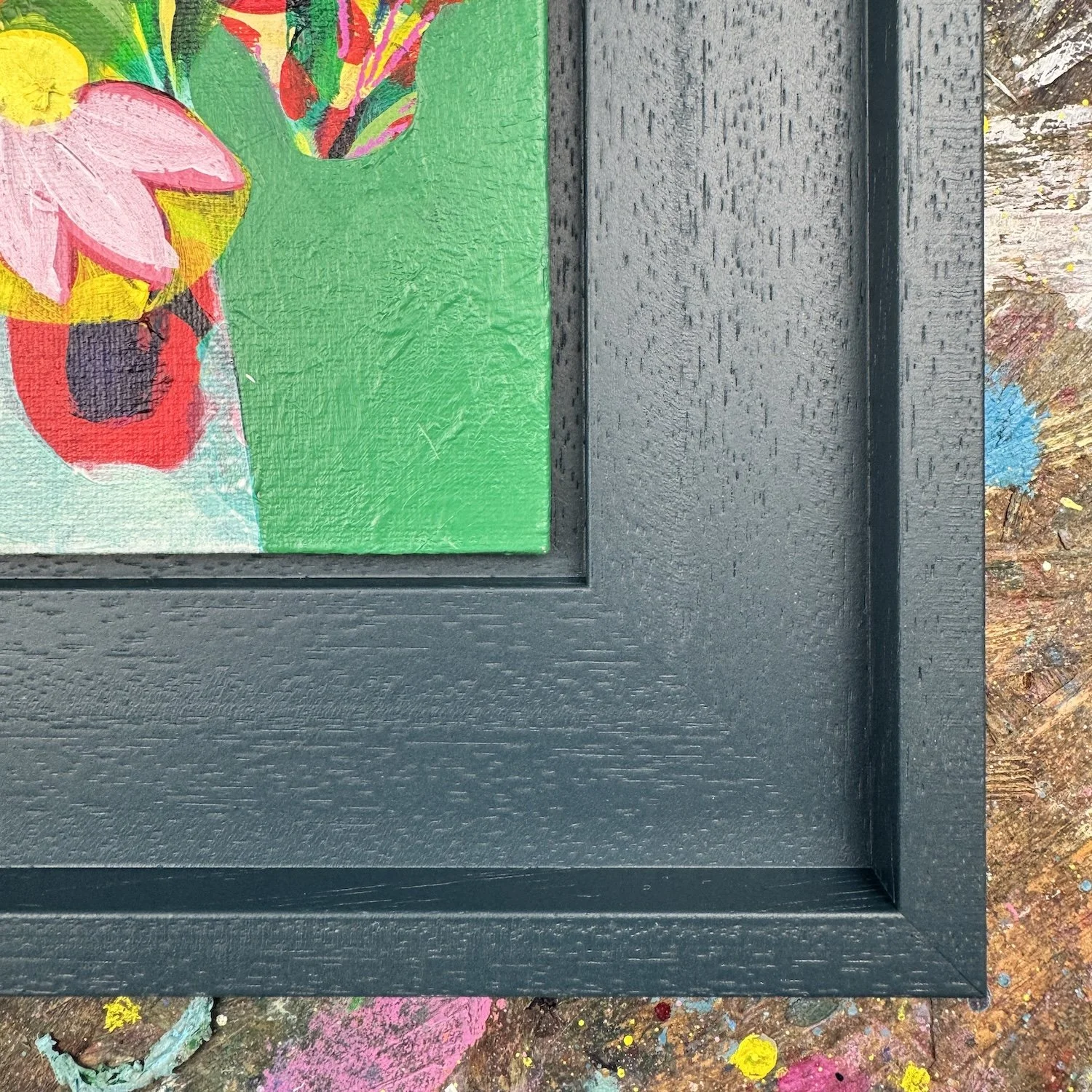 Close-up of textured paint in colourful floral artwork