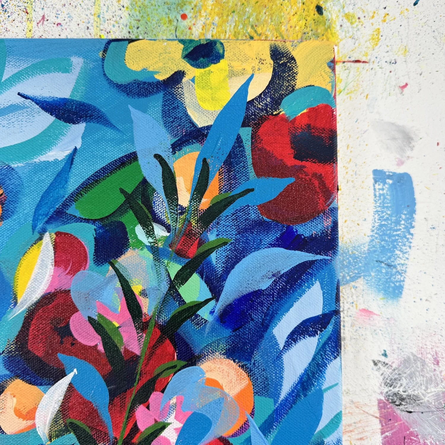 Close-up of small wild blooms in colourful textured painting