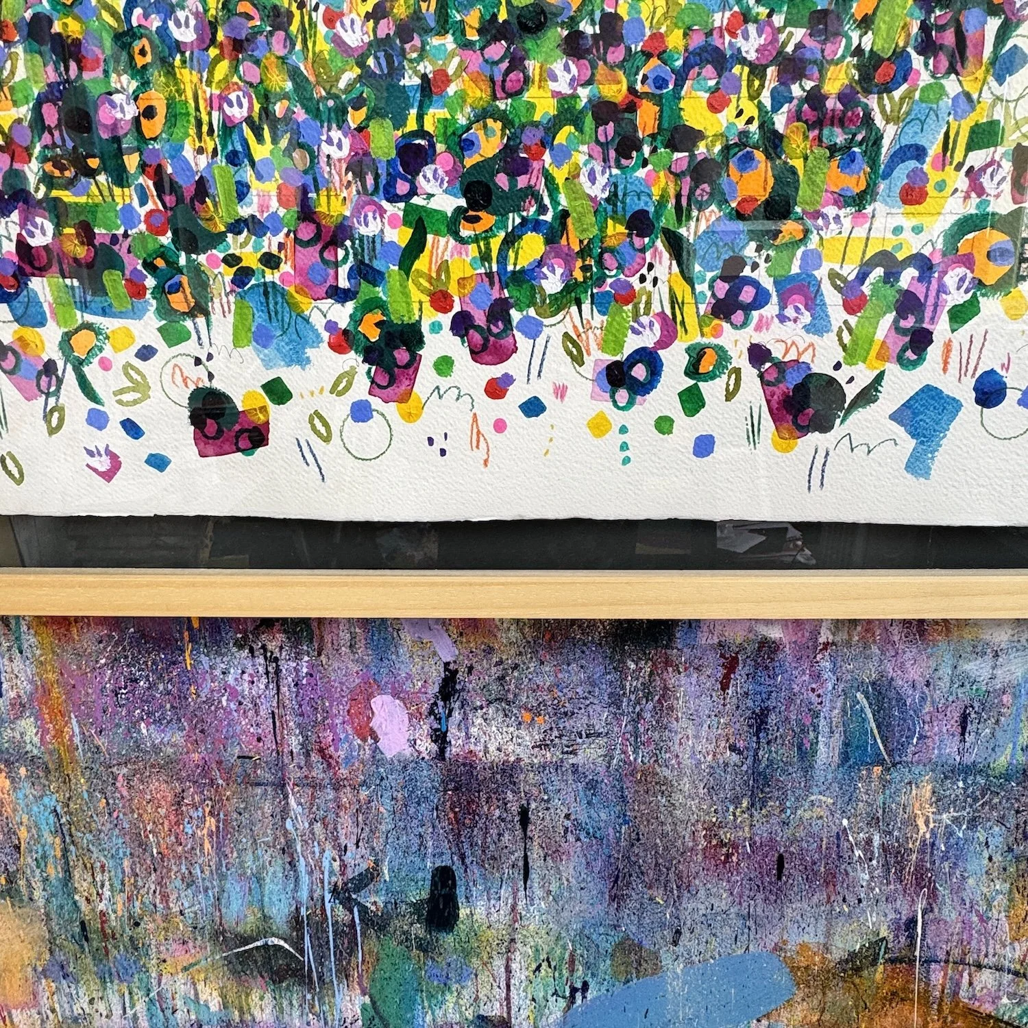 Floral painting framed behind glass with many tiny blooms