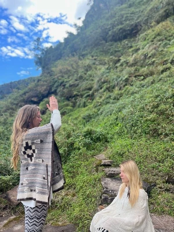 Shamanic teacher Diana Deer Hawk, offering a Munay-Ki rite in nature to a quiet, meditative blonde woman, Aynua Amazonas, Peru