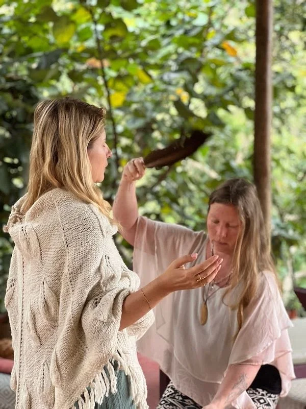 Blonde woman receiving a cleansing ritual during a cacao diet retreat in Northern Peru, Aynua Amazonas
