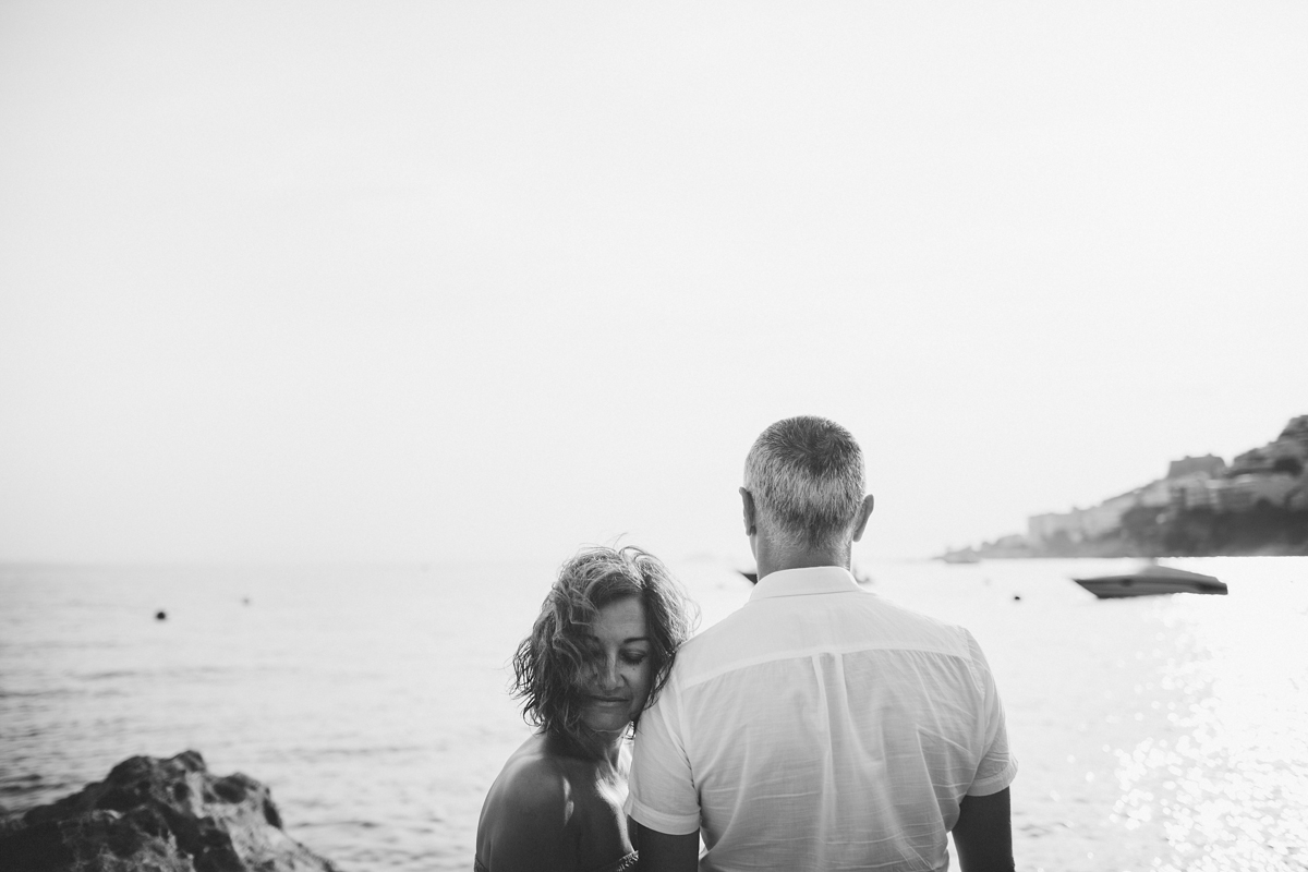 Black and white couple standing in front of the sea