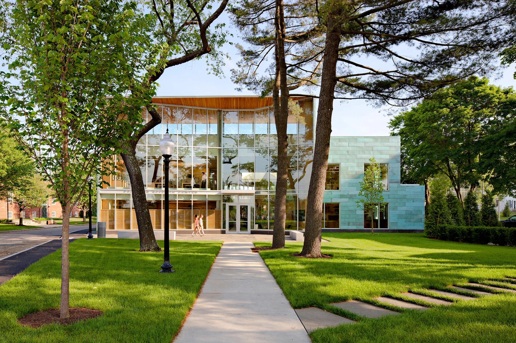 Milton Academy encompasses two separate building projects. The Crossroads Building is a new student-faculty center located centrally on the campus. The Center Street entrance was designed with a south-facing brick terrace defined by bench seating, shade trees and groundcovers. This space is the focal point of a new campus landscape and encourages natural gathering space for faculty and students. Overall, the design eliminates vehicular movement and excess paving, allowing for a pedestrian core that links the four major campus buildings. Nearby, the Pritzker Science Center frames the southern edge of the campus. The main entrance incorporates seating areas which act as extensions of interior classroom space. A stormwater garden runs along the eastside of the building, bringing the School’s environmental ethic to the core of the campus and the community. Collaborators Finegold Alexander + Associates William Rawn Associates Photography Robert Bensen Photography STIMSON Ngoc Doan