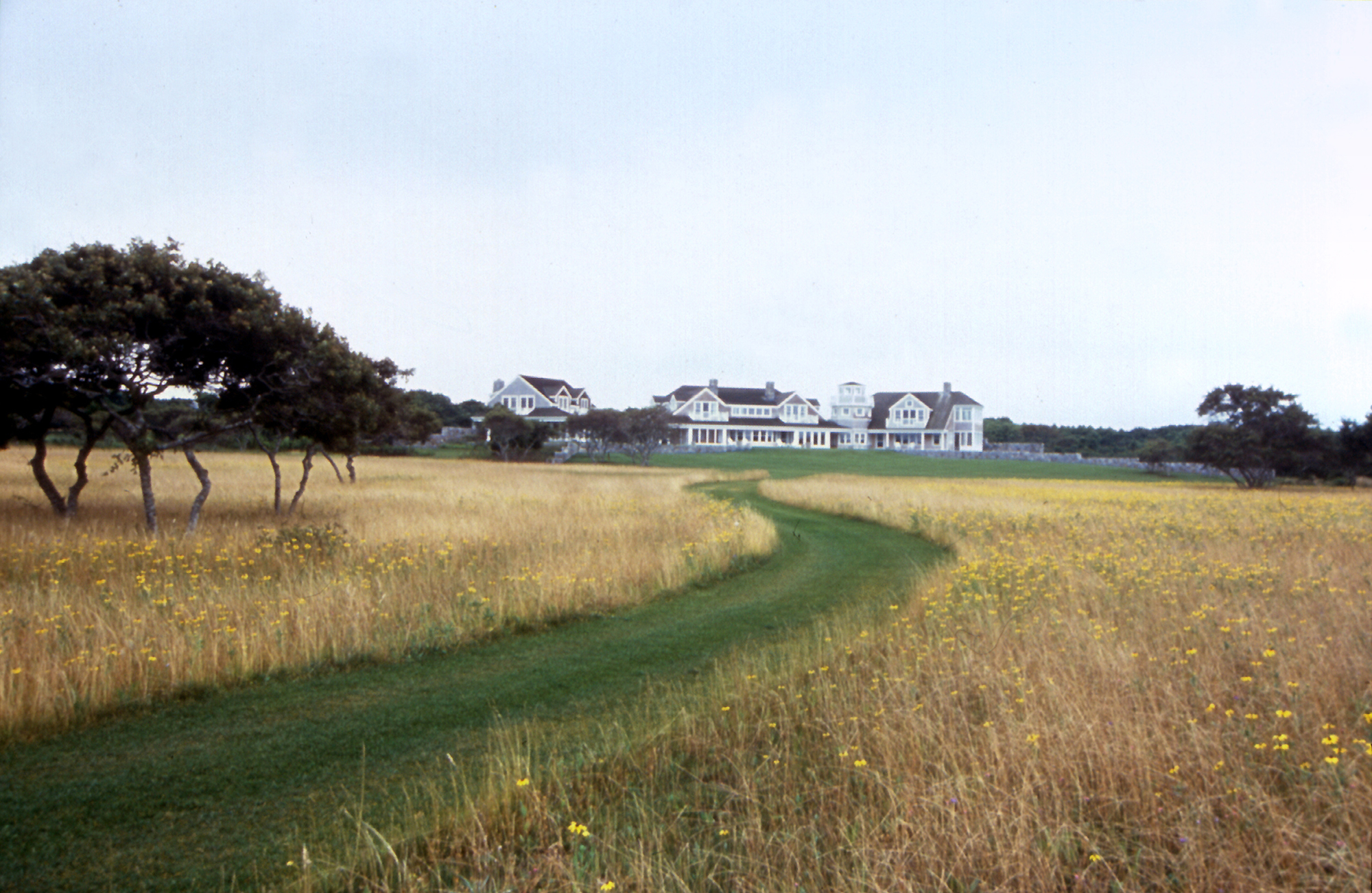 Hawk Rise is located on 30 acres adjacent to Nantucket Harbor on a site characterized by shrub barren uplands and beech, sassafras, and tupelo wetlands. The master plan includes the siting of the main residence, garage, pool and pool house, approach road, and five future residences for the family. New hedgerows will stretch across the site to define areas of meadow and shrub barrens. The stone walls of the house extend into the landscape to define gardens sheltered from the prevailing winds. Recognition Boston Society of Landscape Architects | Honor Award 2002 Collaborators Lyman S.A. Perry Architects, Inc. Photography Charles Mayer