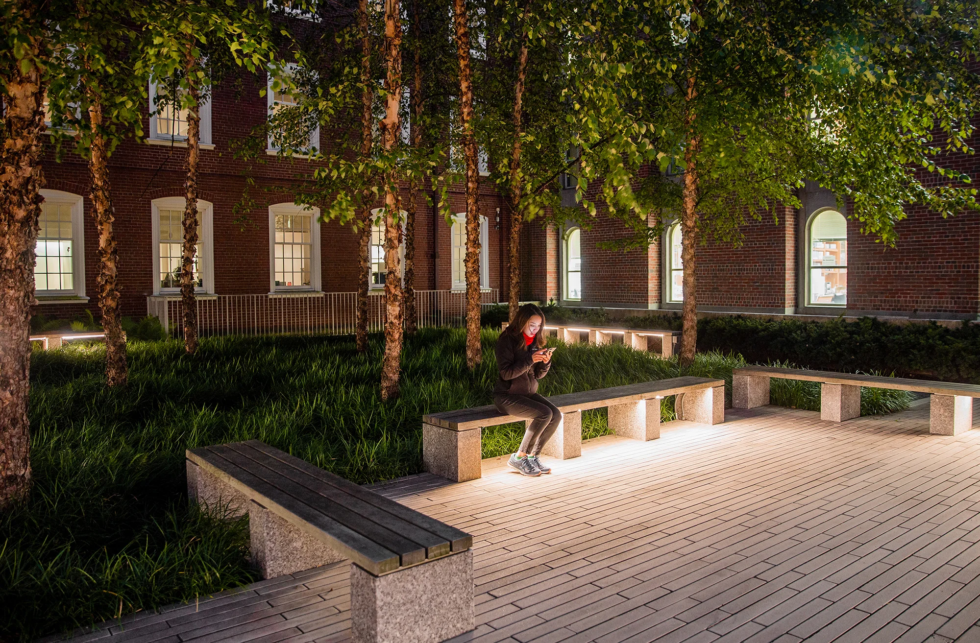 The landscape plan for the Mind Brain Building Renovations at Brown University includes renovation of the streetscape at Thayer, an addition of an accessible ramp at Lincoln Field entrance, and a courtyard design that will serve as both an outdoor informal gathering place and a quieter, contemplative space. A simple planting palette of understory trees, linear evergreen hedges, and groundcover is reminiscent of the more traditional landscapes outside the courtyard. A refined palette of paving materials creates an interesting pattern when viewed from above. The division of a single open courtyard into a gathering plaza and a smaller, more intimate space creates a versatile outdoor space for the Metcalf Mind Brain Building. Photography Ngoc Doan