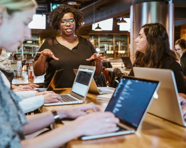 Woman instruction group working on laptops.jpg