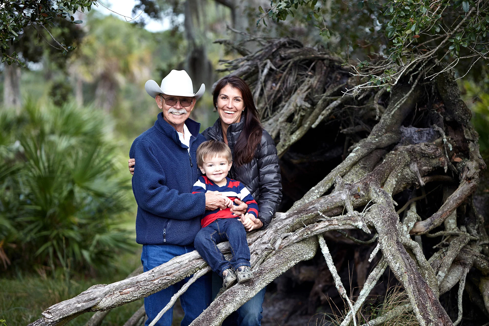 Ralph Pelaez with his daughter, Stephanie Pelaez and grandson McKinley on their 1,375-acre ranch in Okeechobee County. Photo by Randy Batista.