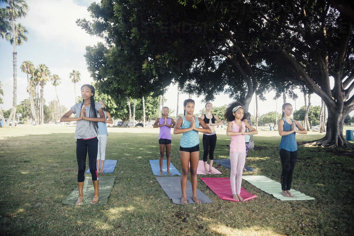 schoolgirls-practicing-yoga-mountain-pose-on-school-sports-field-ISF03567.jpg