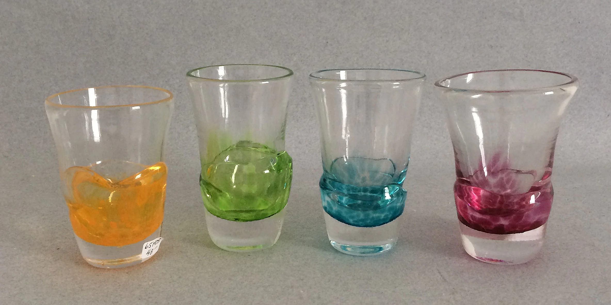 Bonny Houston orange shot glass (left)