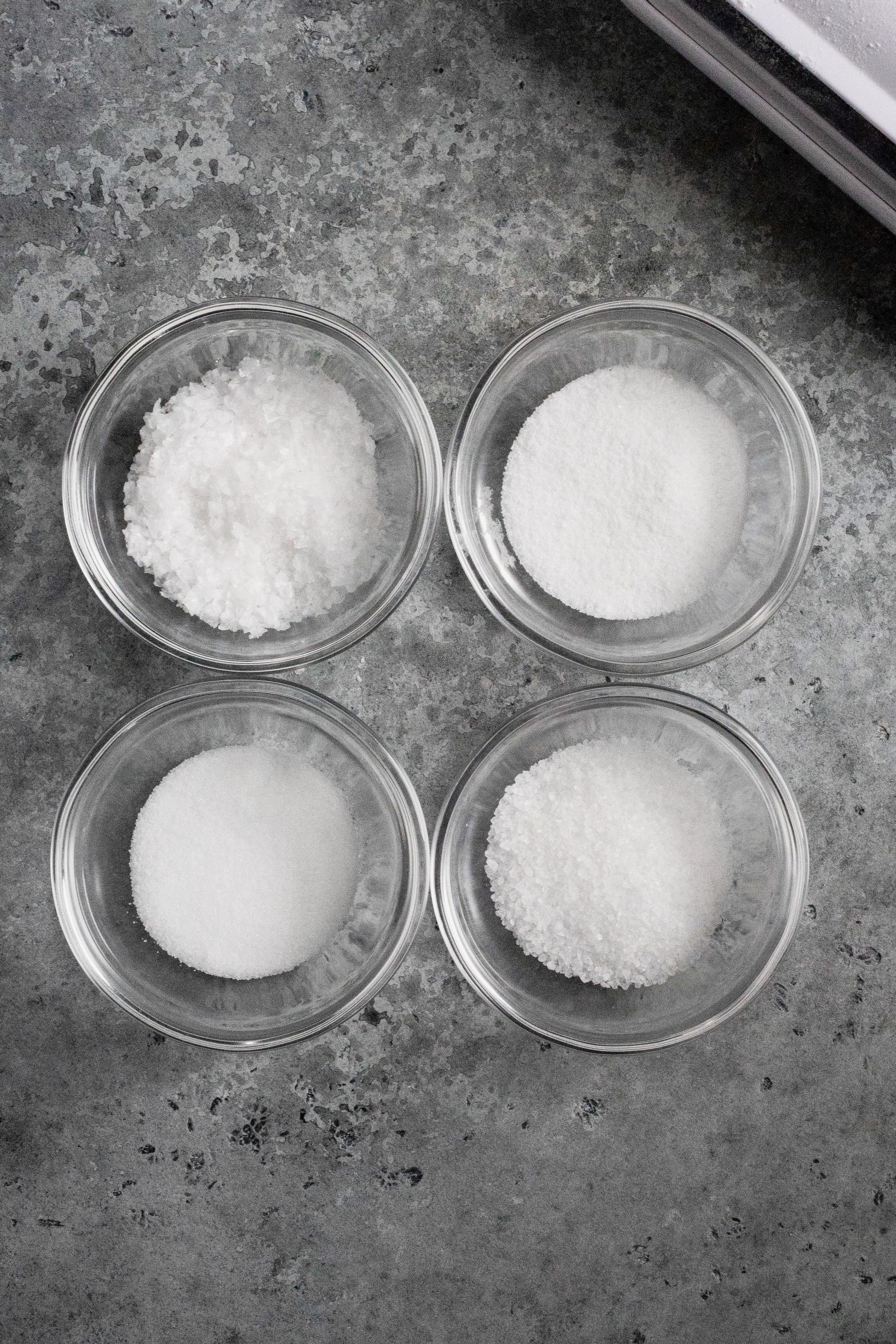 Fleur de sel (top left), fine sea salt (top right), table salt (bottom left), kosher sea salt (bottom right)
