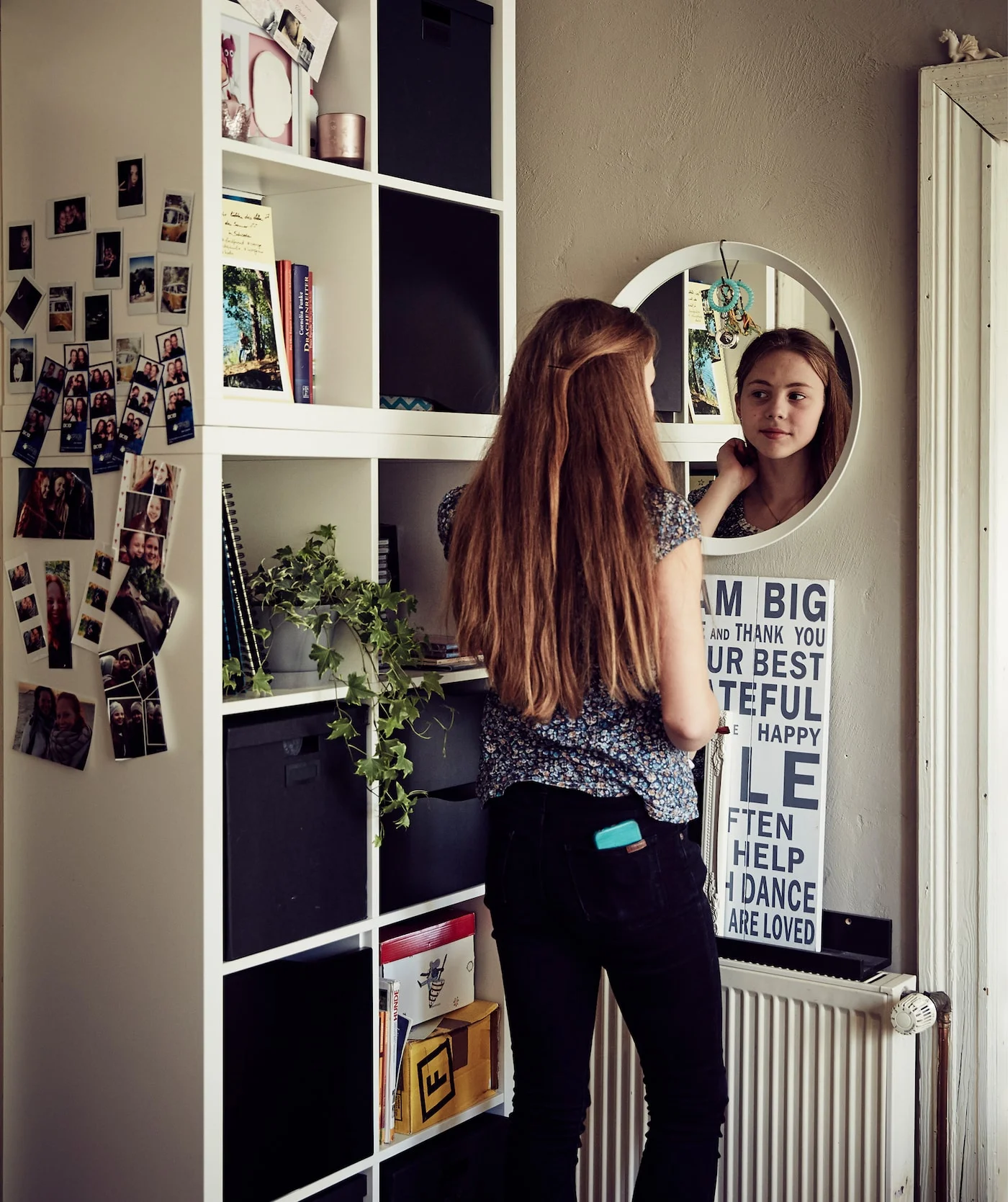 teenager-malin-looking-in-the-mirror-next-to-a-cubed-storage-3d9a97b47cd9c2c6aeabd135a734677b.jpg