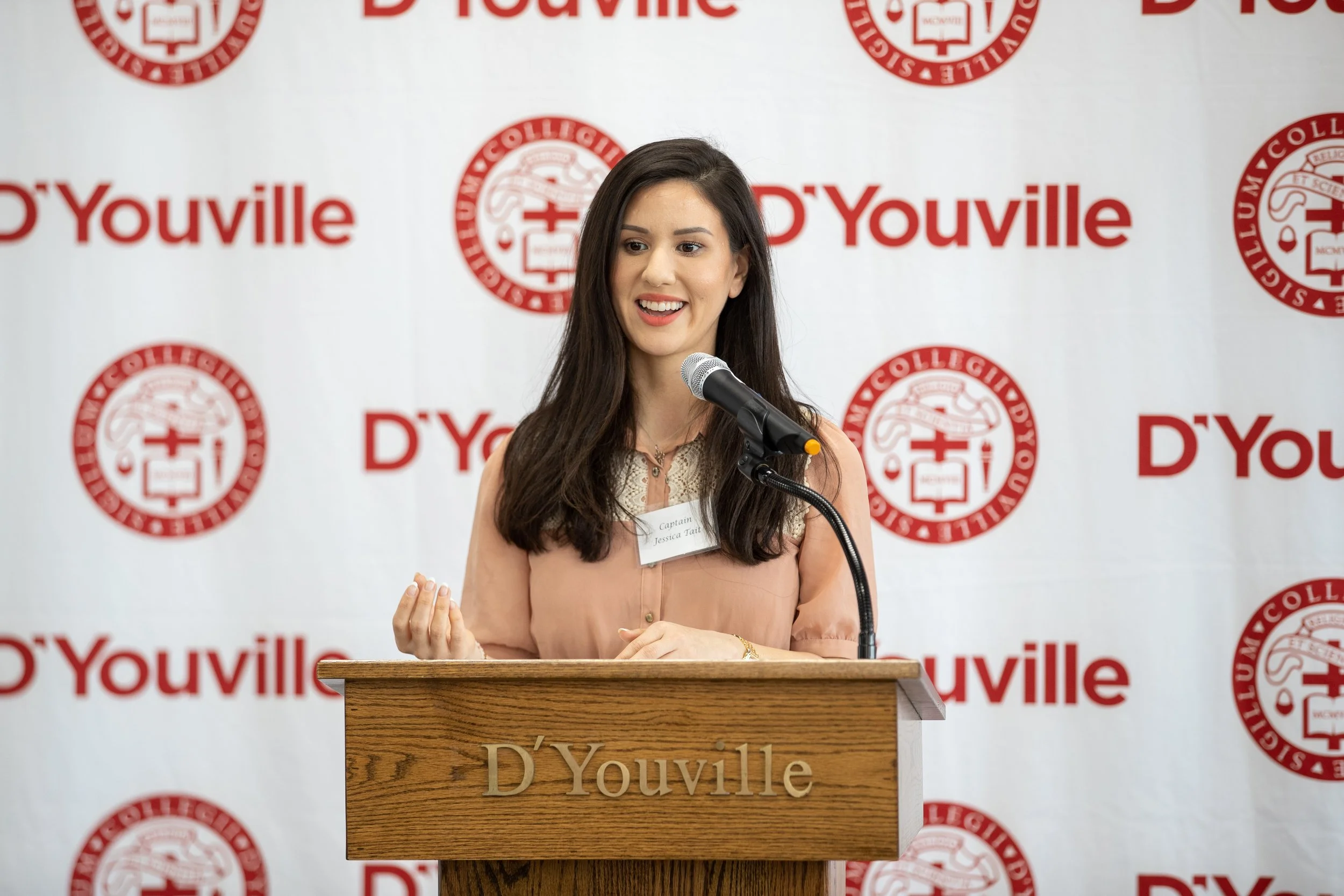 Jessica Tait speaking at a podium during D’Youville University’s 2019 commencement events in Buffalo, New York.