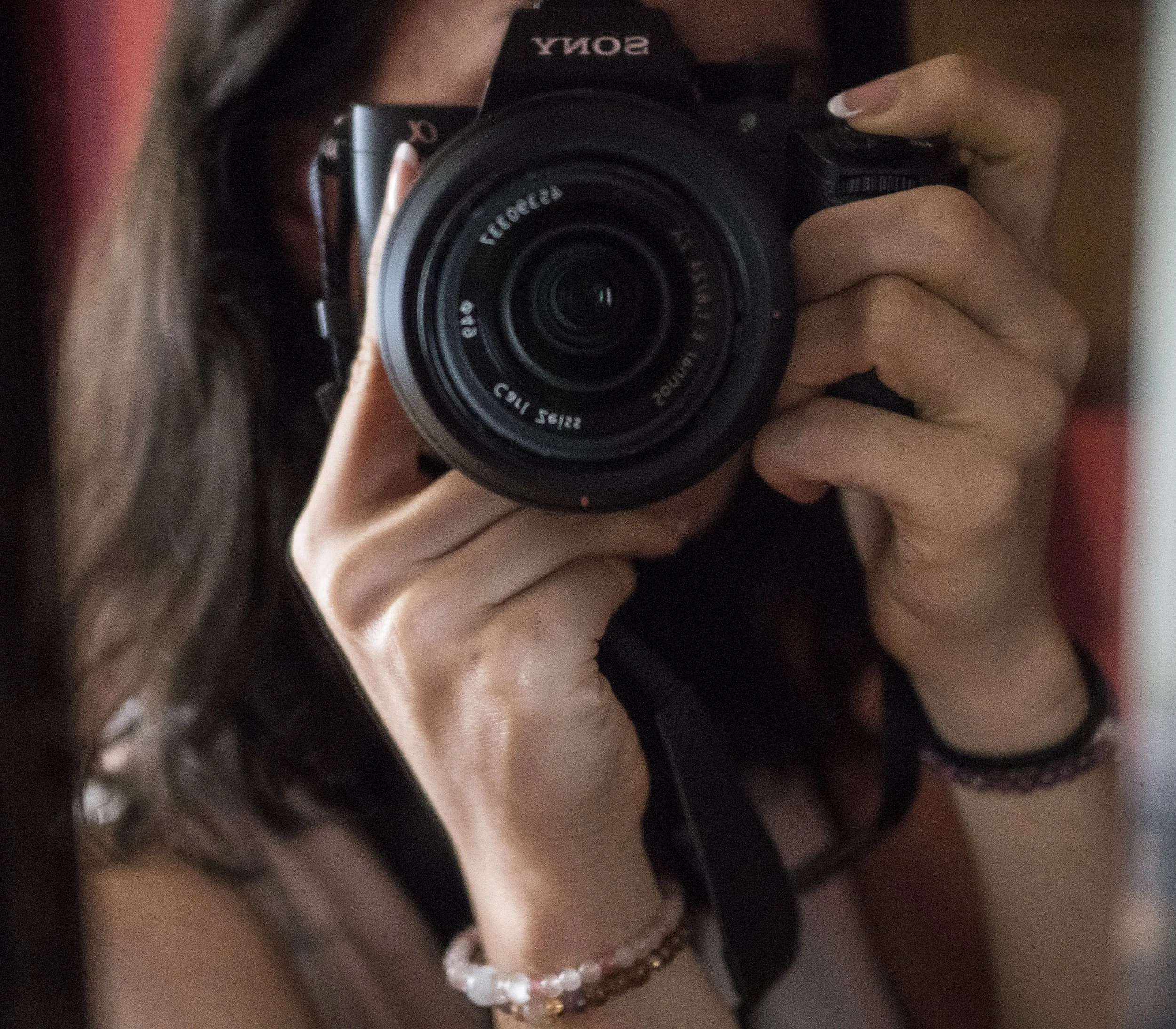Jessica Tait photographs her reflection with a Sony camera.