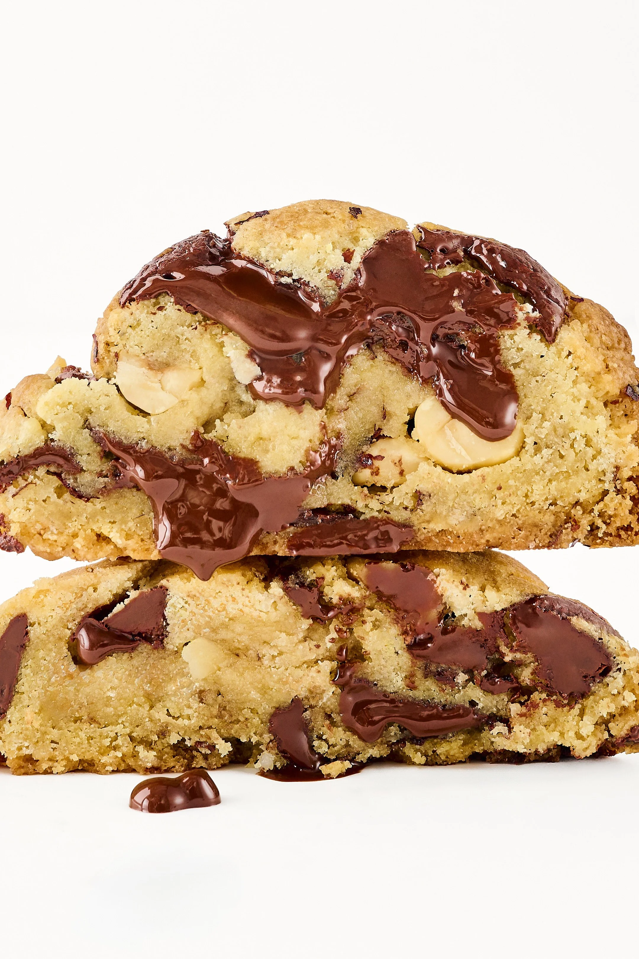 Close-up of chocolate chip cookie with melted chocolate on top, on a white background