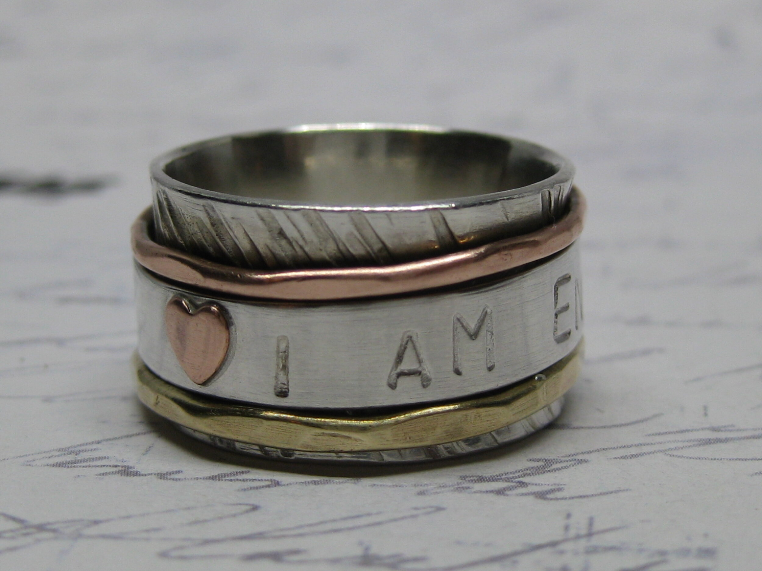 Side 1 of mixed metal "I am enough" spinner ring