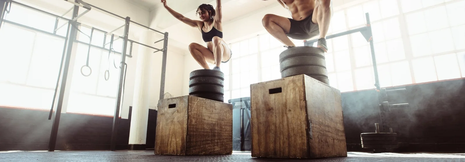 fitness couple in the gym doing a box squat.jpg