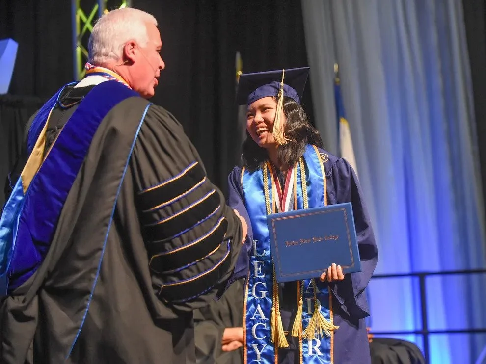 Person walking in commencement ceremony
