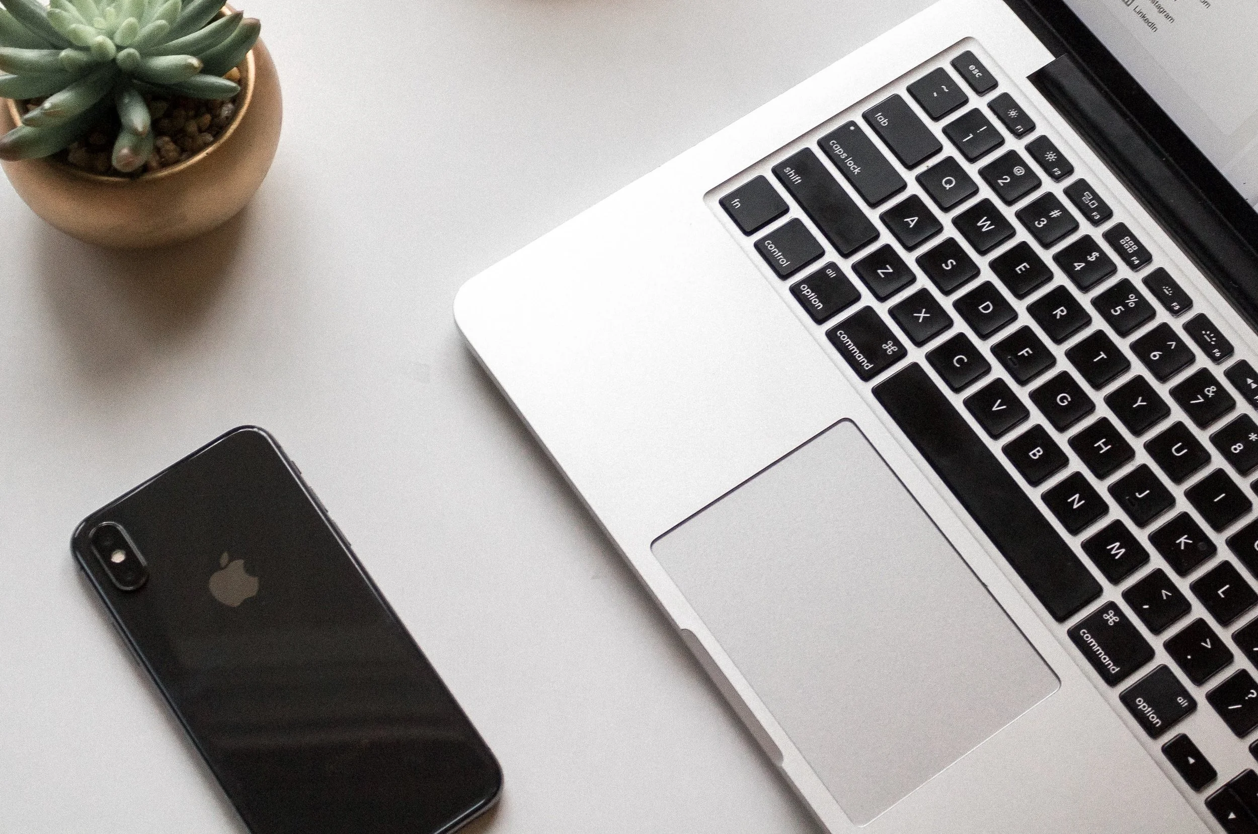 Computer and phone sitting on table