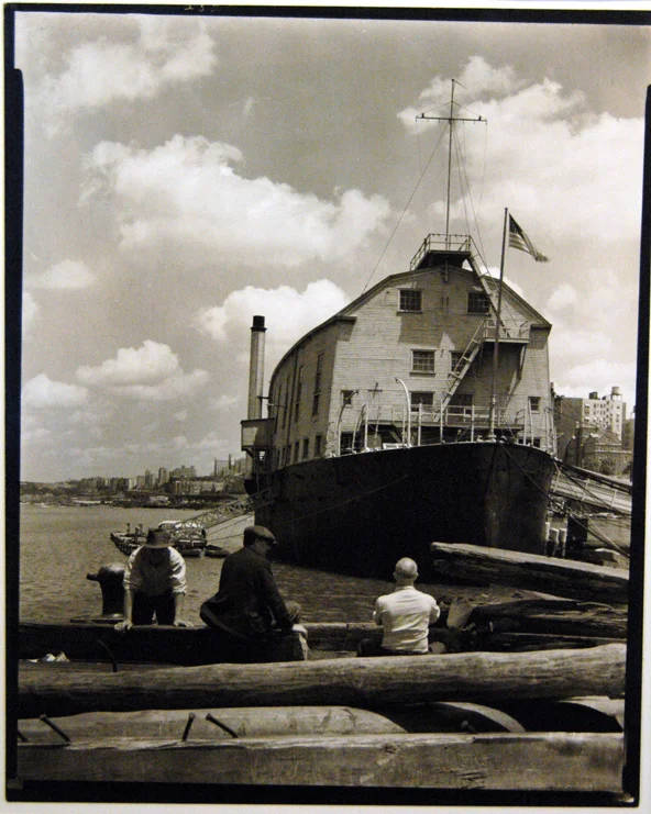 3 story tall wood boat docked people foreground