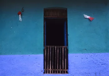 Gated Window on blue adobe wall