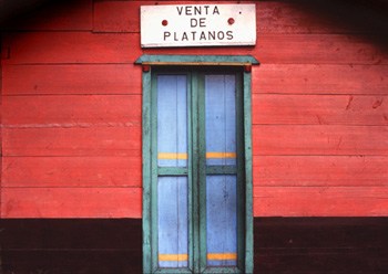 Blue door against red black wall with sign
