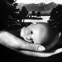 hand holding doll head