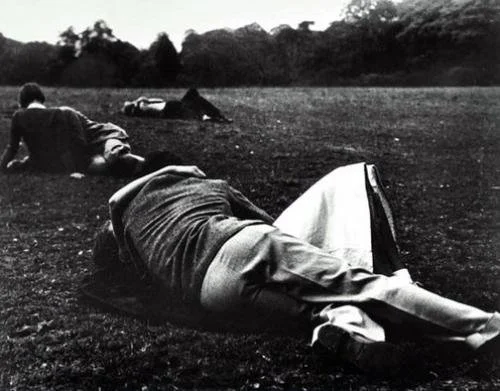 Couples making out laying in park field