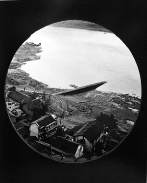 arial view of japanese seaside town through circular port window