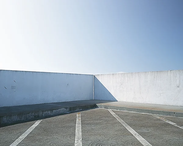 blue sky bisected by parking garage roof