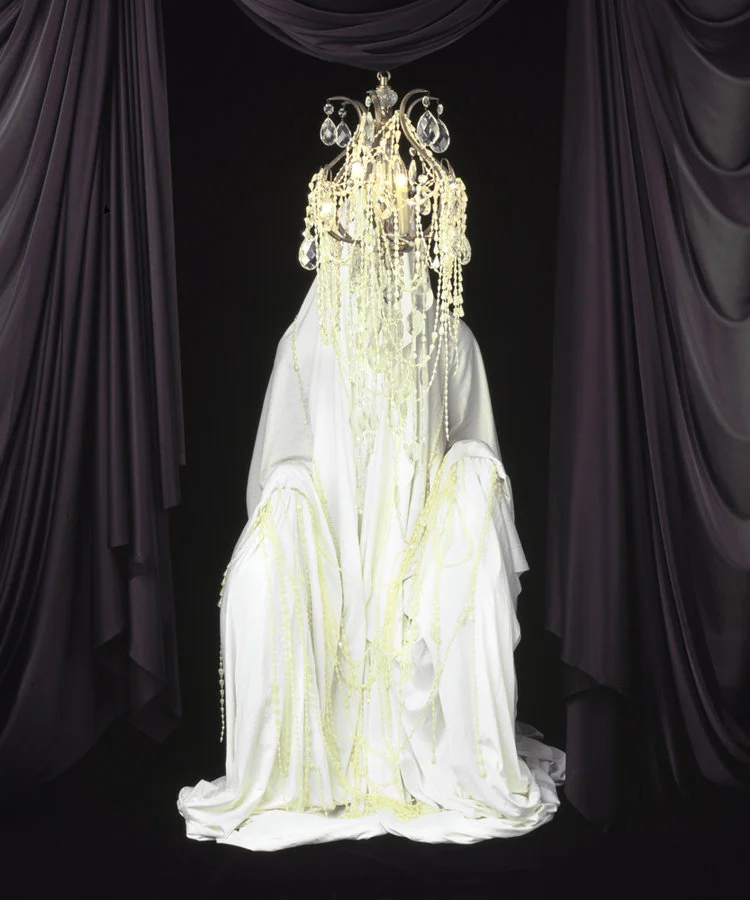 Black Drapery chandelier at the head of a human ghost drapery
