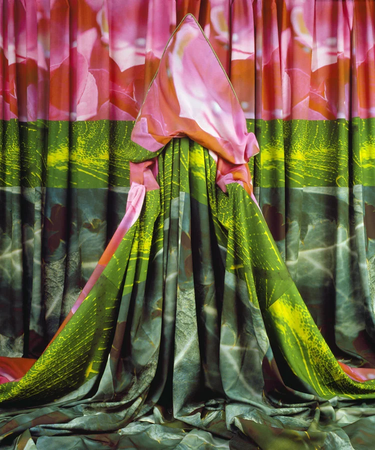 model draped in fabric coordinated with curtain pink and green tropical